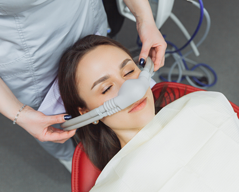 Female dental patient receiving nitrous oxide sedation