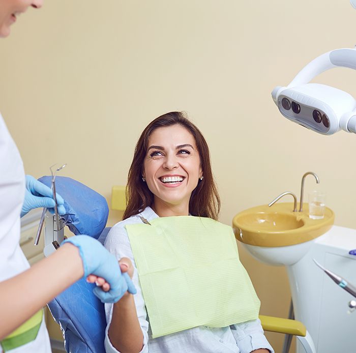 Patient shaking hands with dentist