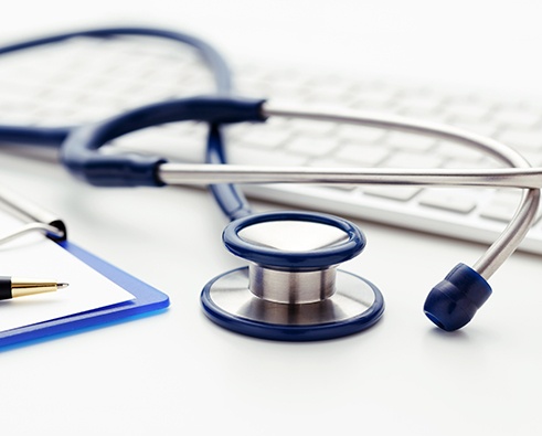 Stethoscope on top of computer keyboard