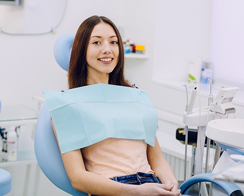 Smiling patient in dental treatment chair