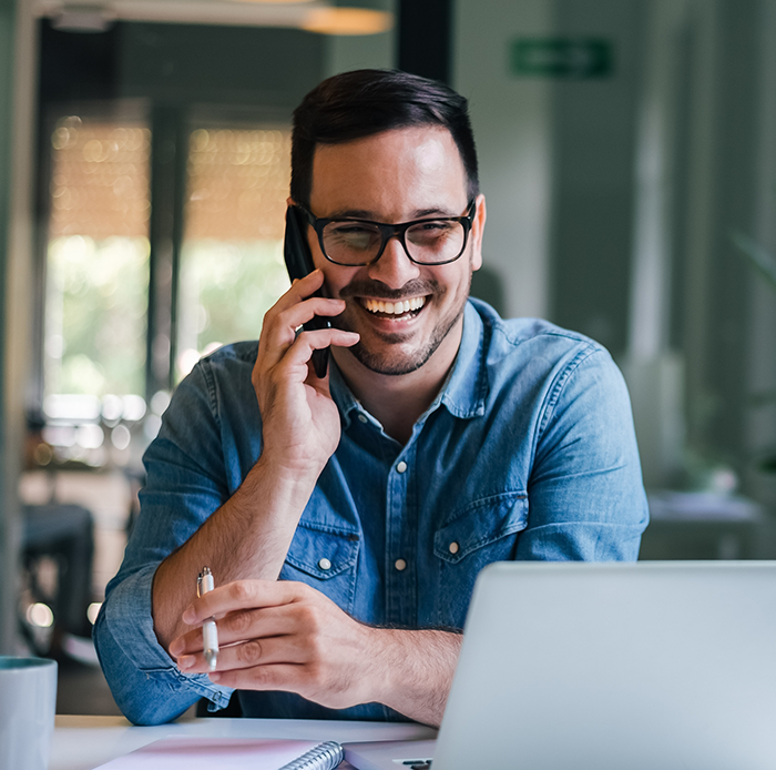 Man smiling and talking on phone