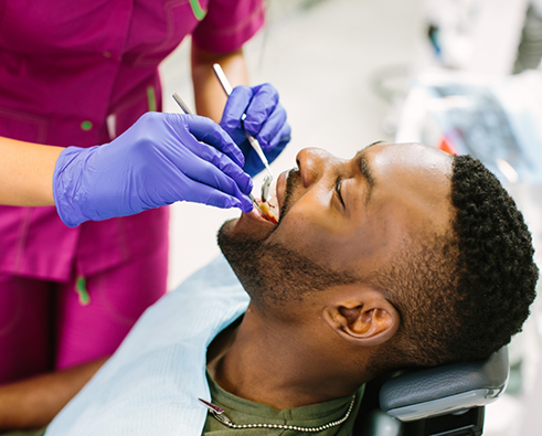 Male patient receiving dental cleaning for preventive dentistry in Houston