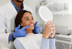 a patient admiring their smile in a handheld mirror